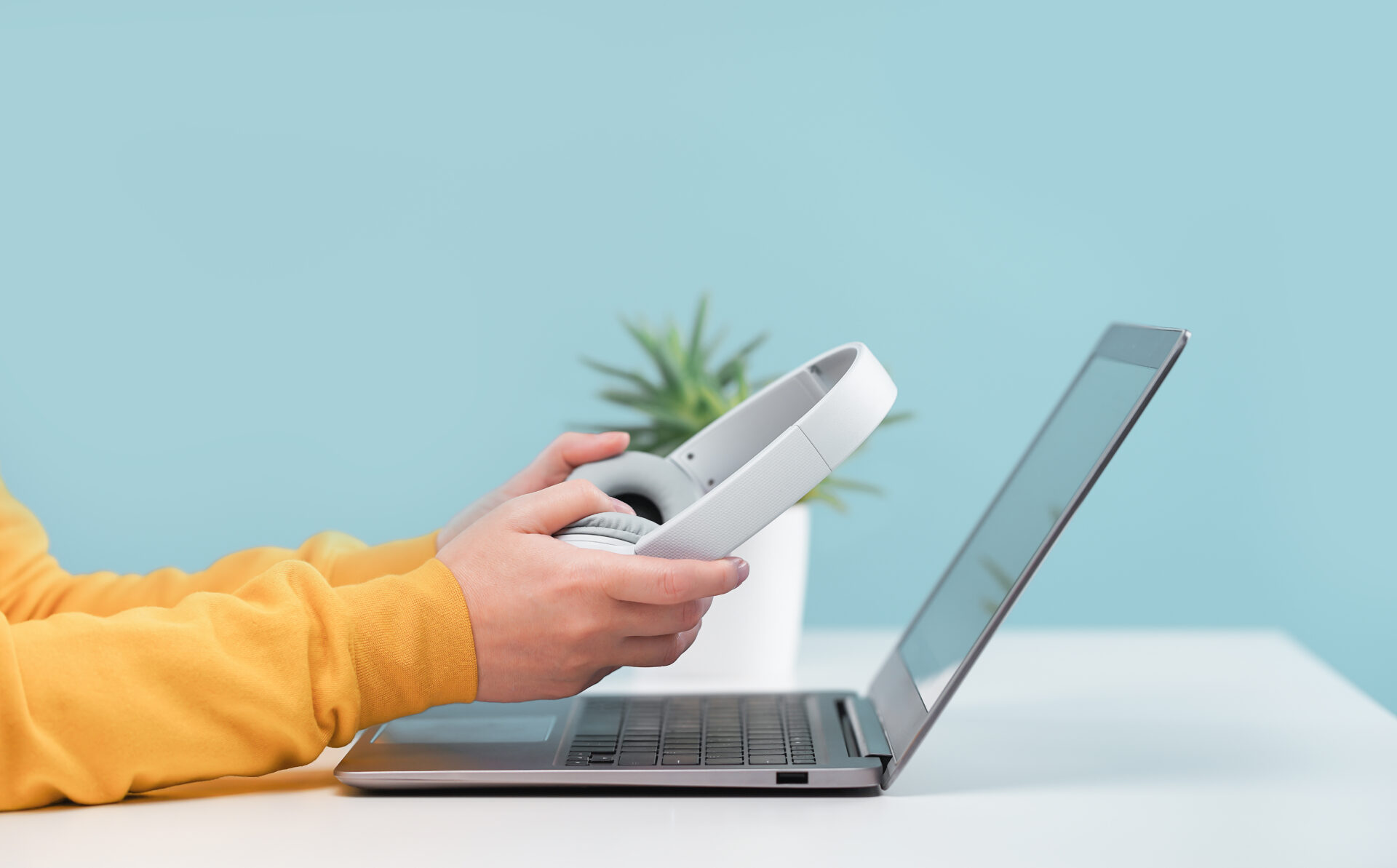 Laptop with headphones on white desk