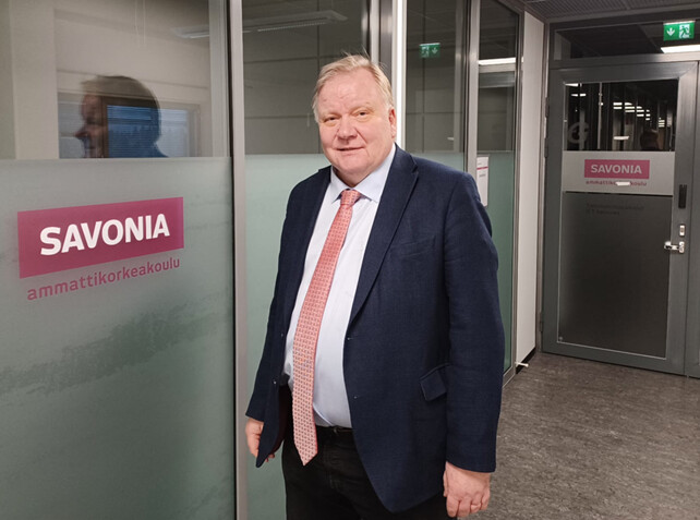 Kuvassa mieshenkilö poseeraa kameran edessä.