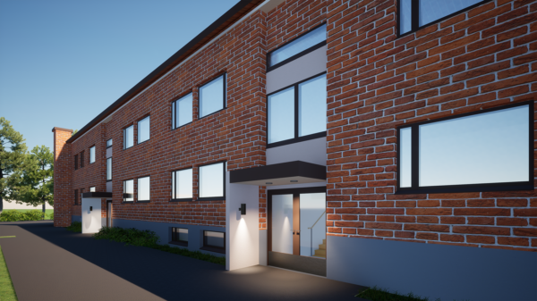 Moderni kaksikerroksinen tiilikerrostalo, jossa on suuret ikkunat, tasakatto ja lasipaneeliset sisäänkäyntiovet, kirkasta sinistä taivasta vasten ja vehreyden ympäröimänä.
