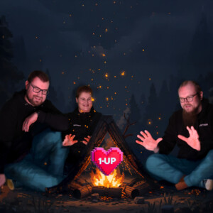 Kolme ihmistä istuu nuotion ympärillä pimeässä, metsäisessä maisemassa, joka on saanut inspiraationsa Minecraftista. Nuotion yläpuolella leijuu hehkuva 1-UP-sydän, ja oikealla puolella seisoo ryömijä. Ryhmä vaikuttaa iloiselta ja rennolta.