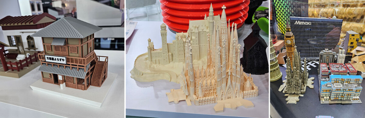 Esillä on kolme erilaista 3D-tulostettua, yksityiskohtaista rakennuksen pienoismallia: puurakennus, monimutkainen katedraali ja korkeat, modernit pilvenpiirtäjät.